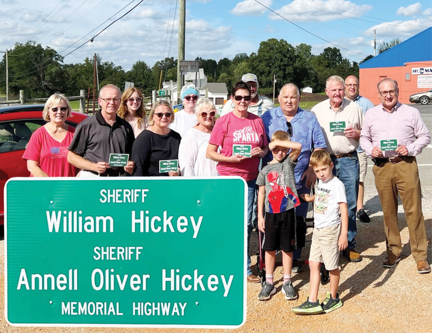 The family members of William and Annell Hickey, along with several dignitaries, gather to dedicate a section of State Highway 136 (Old Kentucky Road) to the husband and wife who both served as sheriffs.